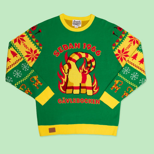 Grön stickad jultröja med motiv av den brinnande Gävlebocken från Svenskhusman på ljusgrön bakgrund.